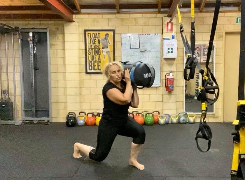 Sandbag lunge training at the Hell's Bells Fitness studio in Ballajura