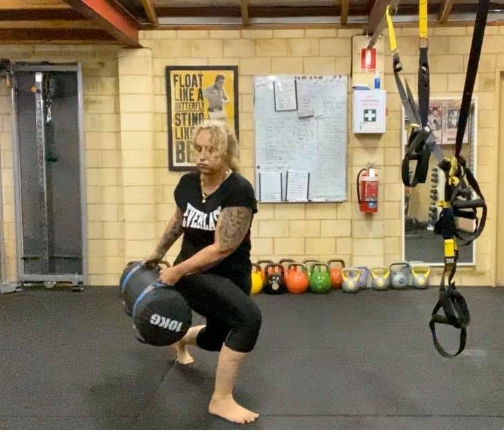 Sandbag squat training at the Ballajura studio